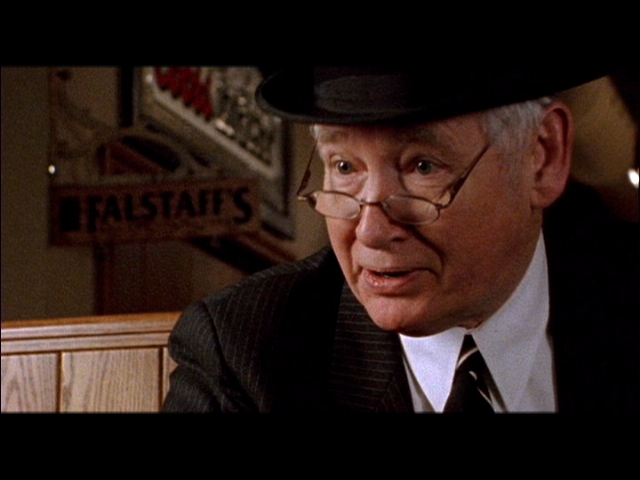 John Henley as Burton Kemble, Contract Killer salesman