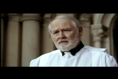 John Henley as The Priest in a Hot Docs commercial